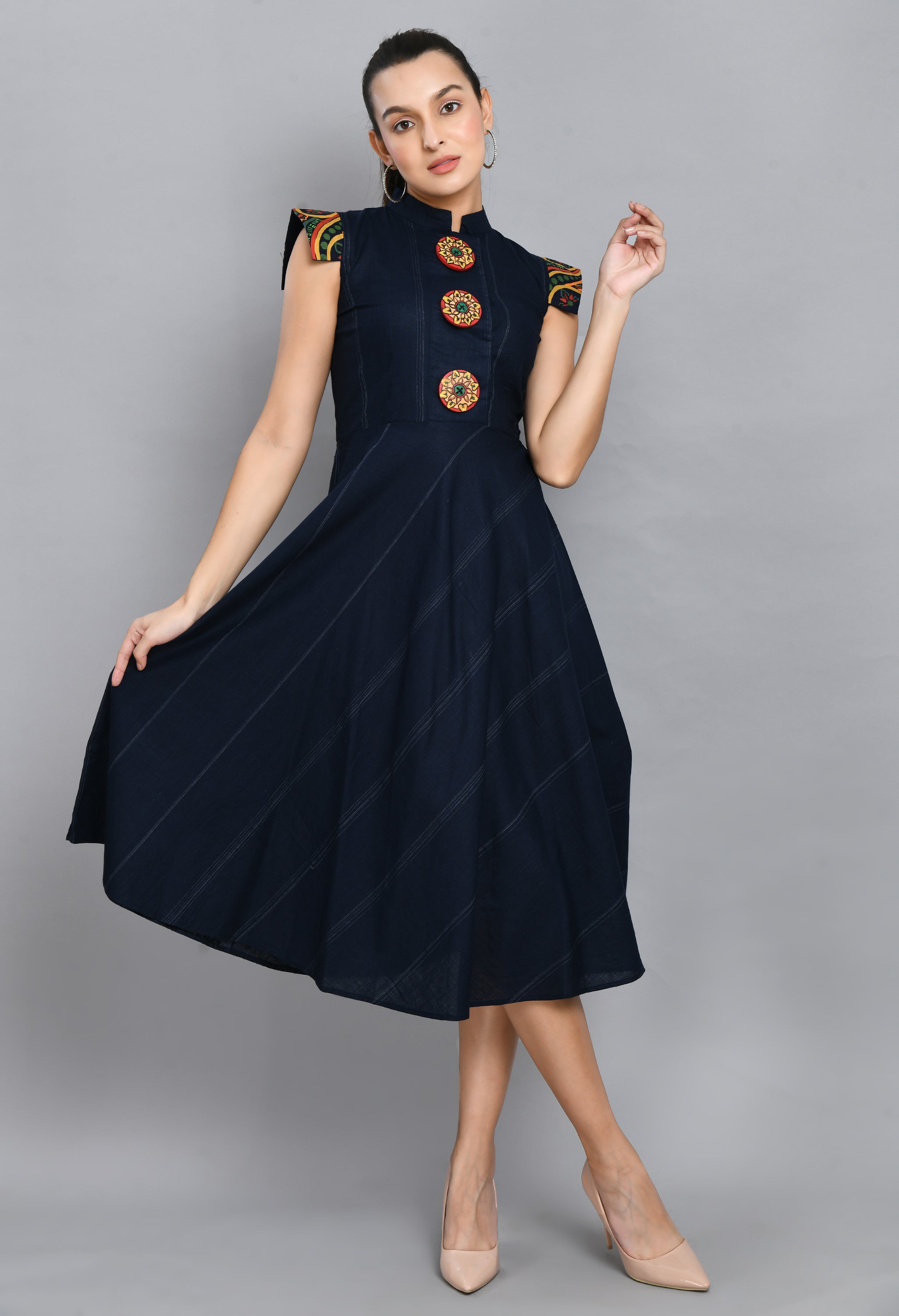 A beautiful blue linen dress featuring hand-painted sleeves and buttons, showcasing unique artistic designs.