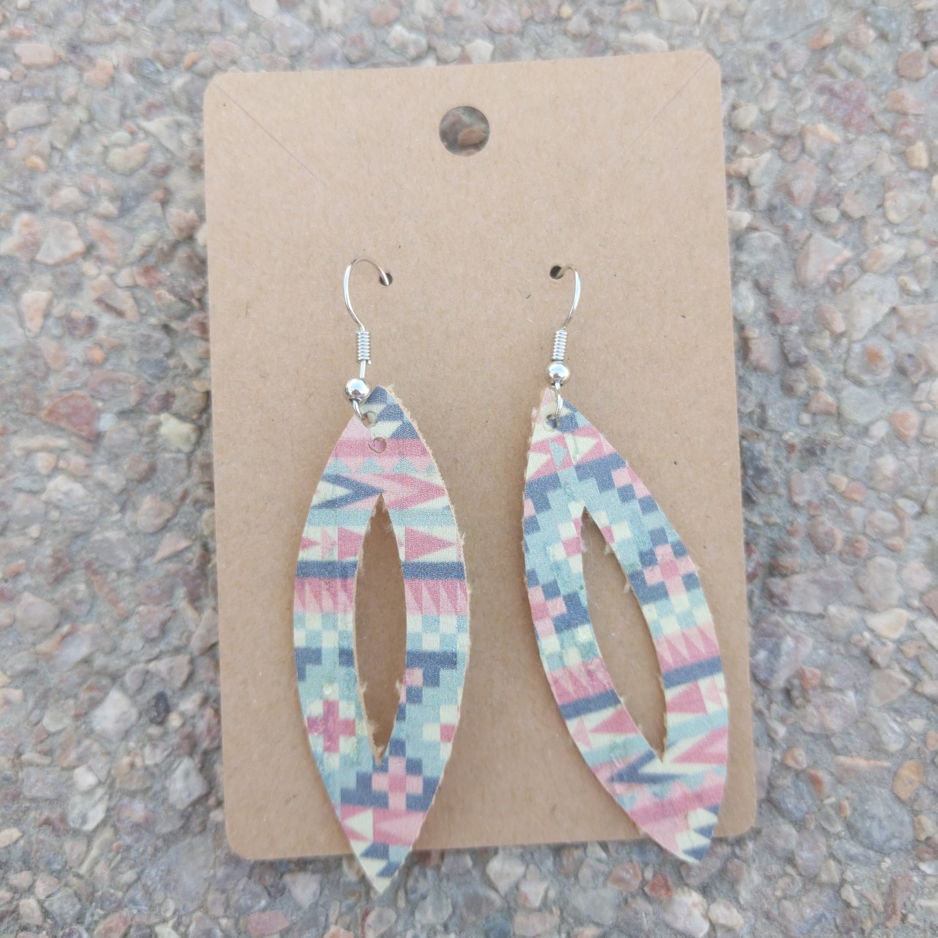A pair of handmade Aztec faux leather earrings featuring intricate patterns, lightweight design, and a stylish look.