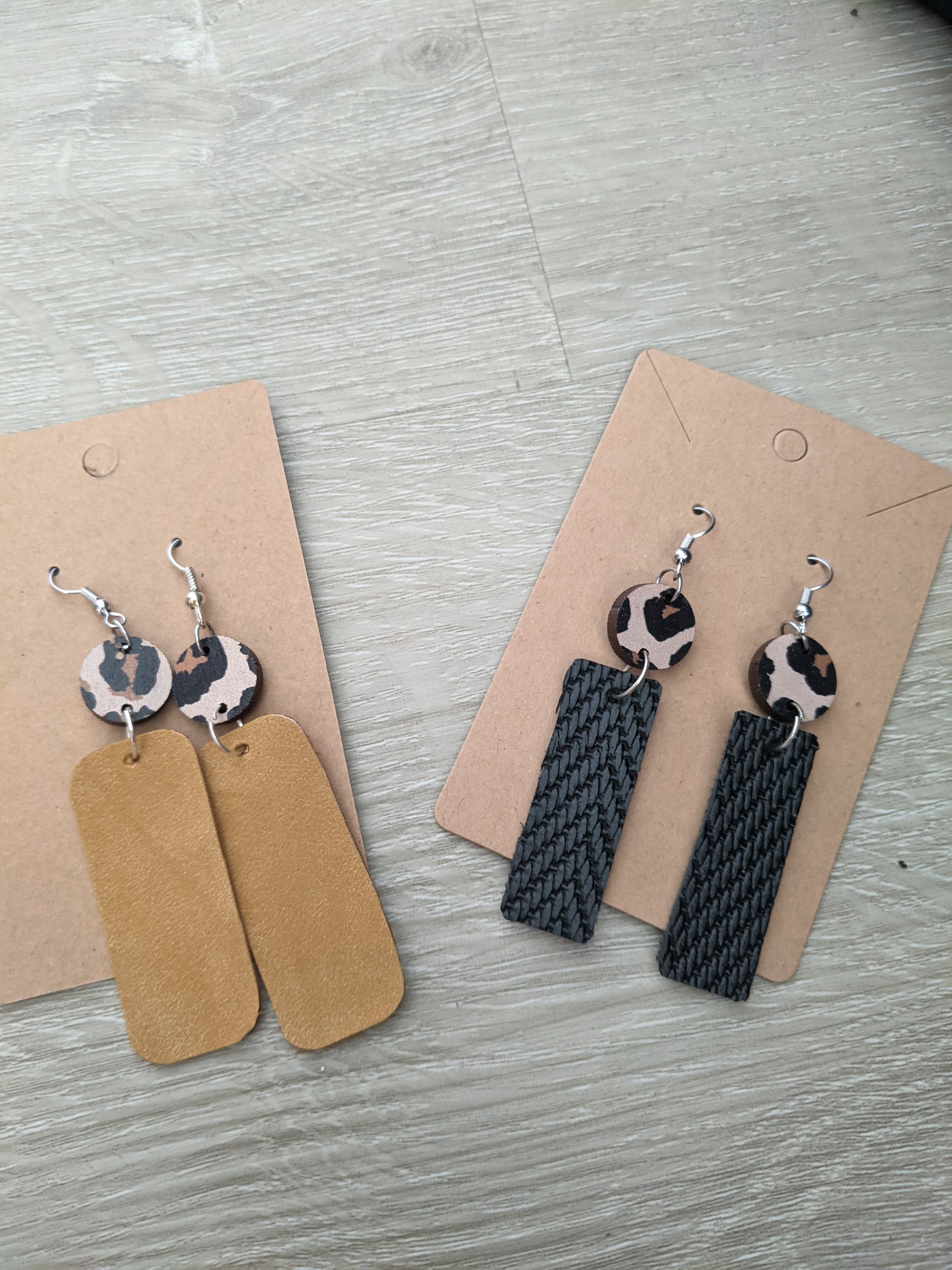 Handmade faux leather earrings featuring a unique wooden animal print detail, lightweight and stylish, measuring about 1.5 inches.