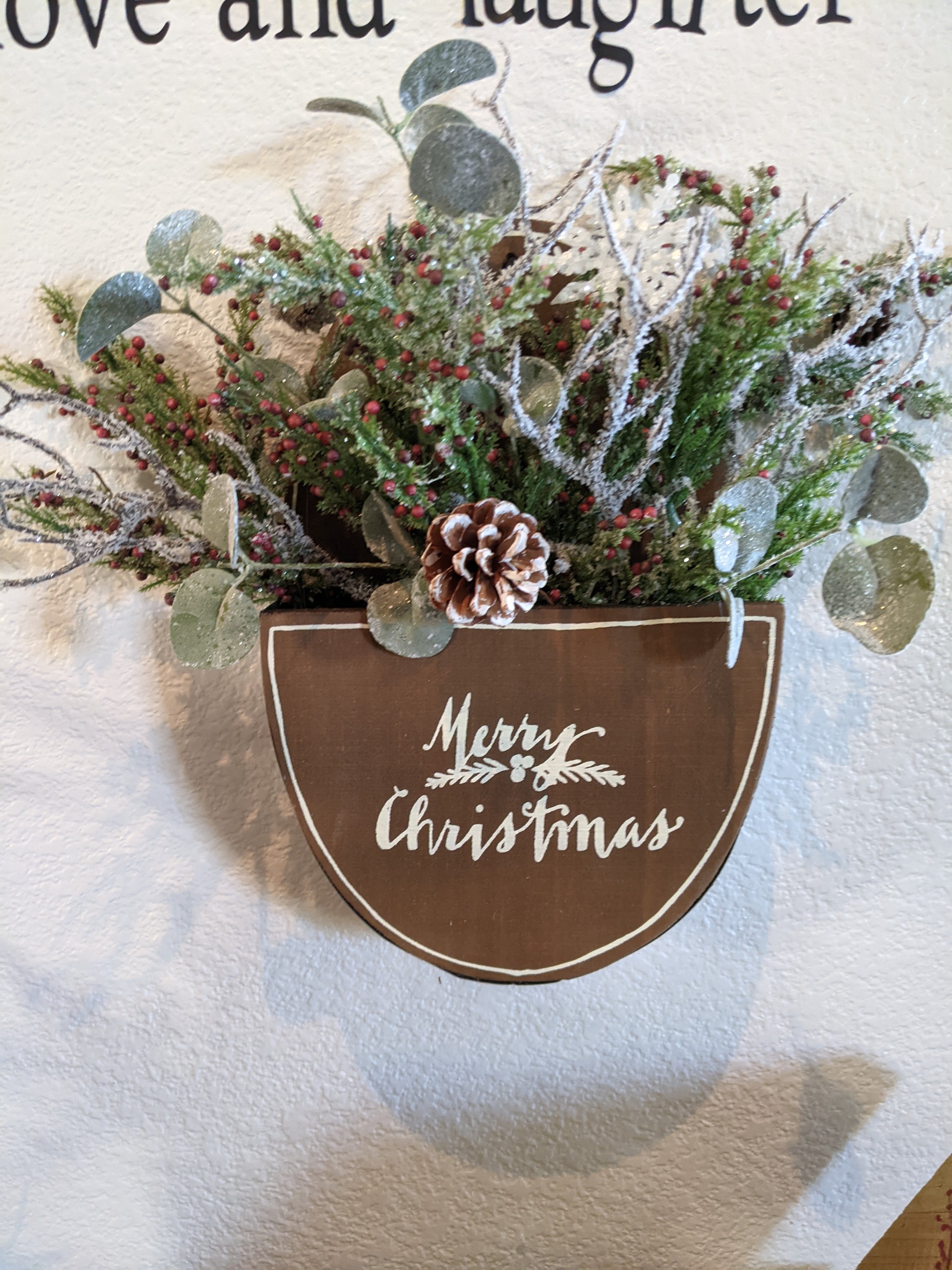 Handmade wooden Merry Christmas box featuring winter greenery and vibrant berries, perfect for holiday decor.