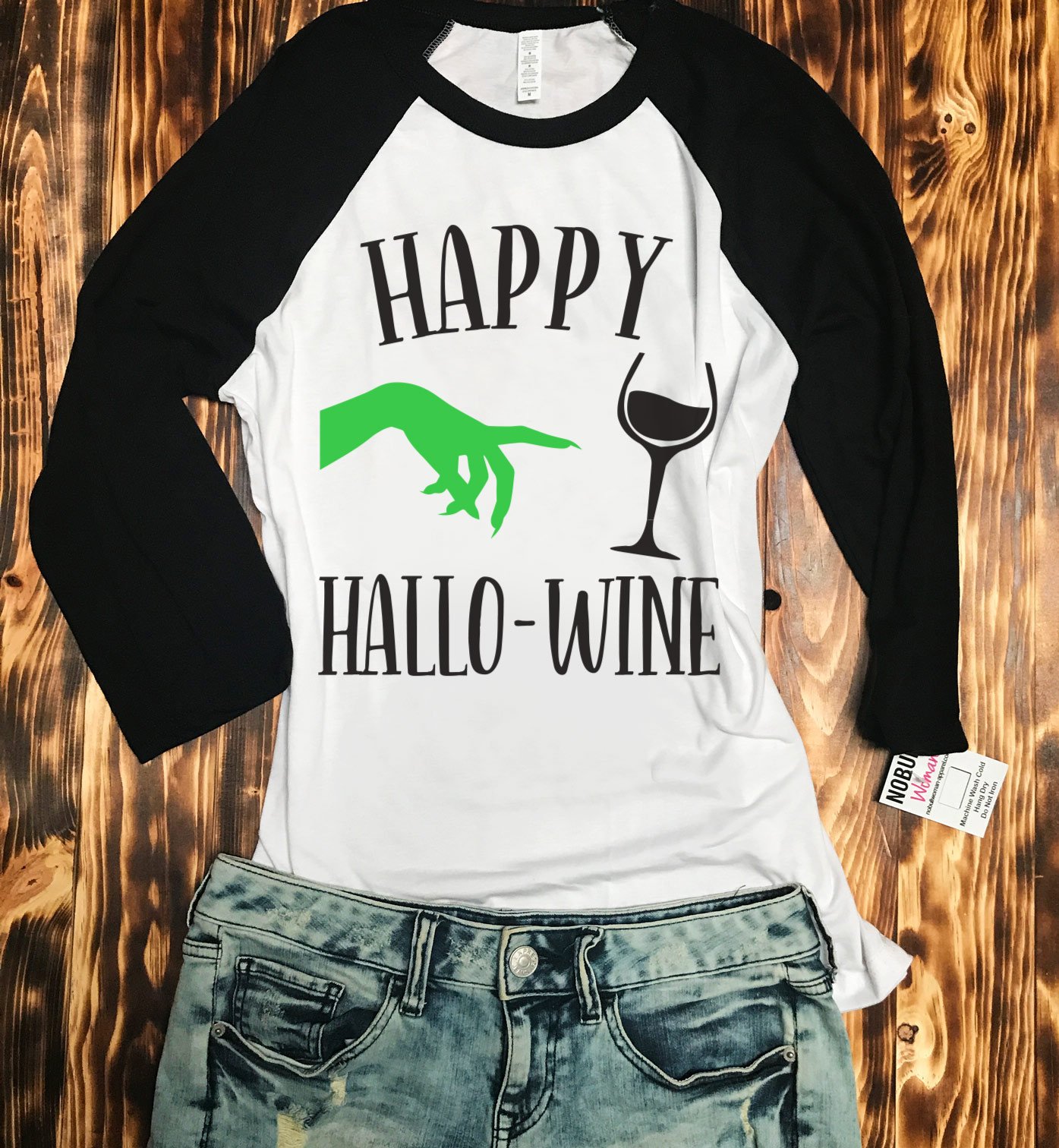 Happy HalloWine Witch Baseball Tee featuring a playful Halloween design with white body and black sleeves.