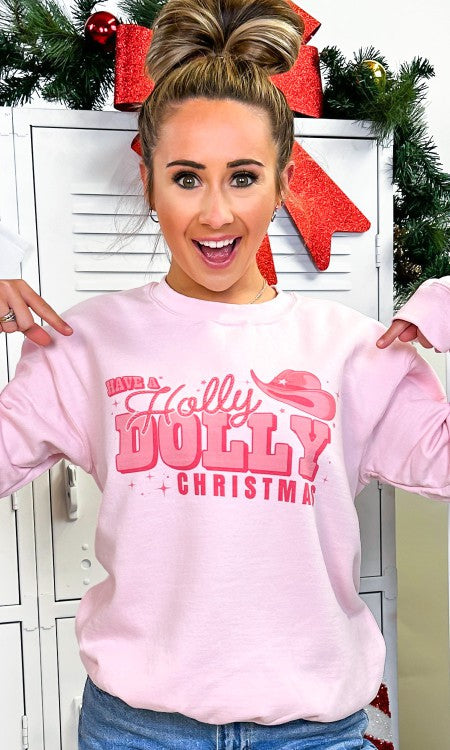Light pink sweatshirt featuring 'Have A Holly Dolly Christmas' graphic with cowgirl hat and sparkles.