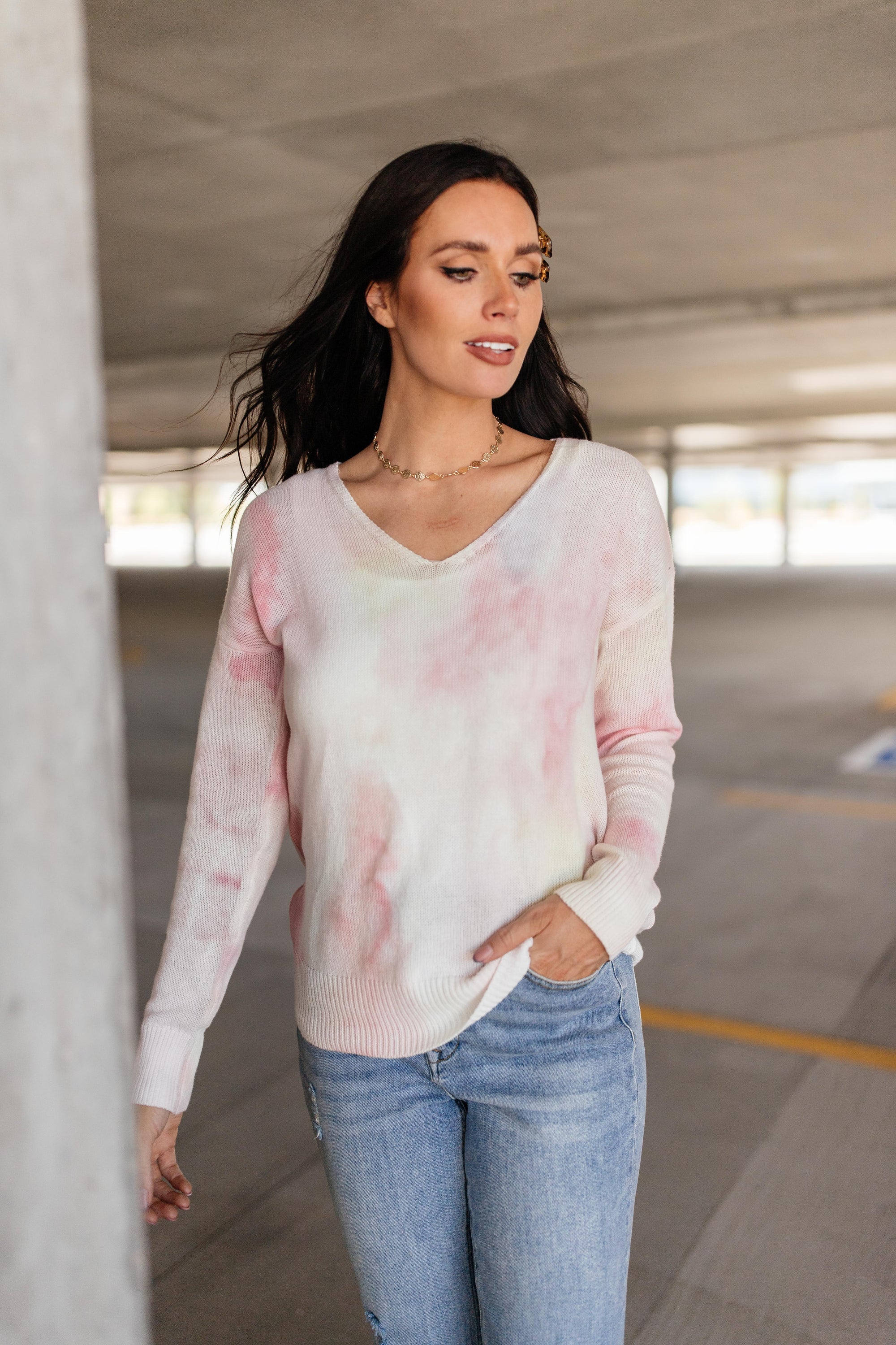 Heavenly Sweater in pale yellow and pink, featuring a wide v-neckline and long sleeves, made from lightweight knit fabric.