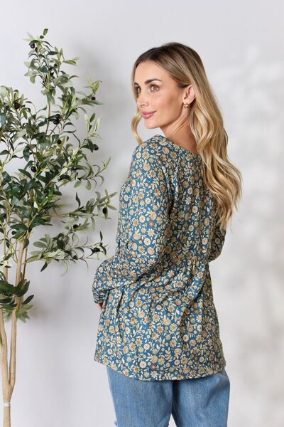 Heimish Full Size Floral Half Button Long Sleeve Blouse featuring a chic notched neckline and vibrant floral pattern.