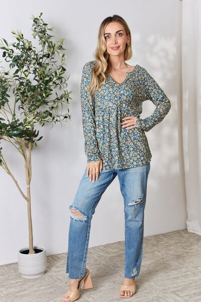 Heimish Full Size Floral Half Button Long Sleeve Blouse featuring a chic notched neckline and vibrant floral pattern.
