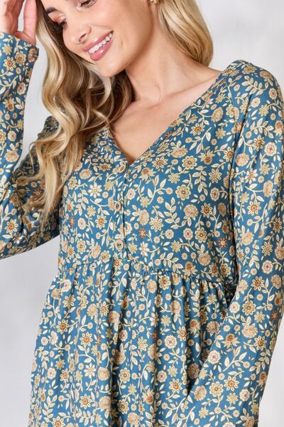 Heimish Full Size Floral Half Button Long Sleeve Blouse featuring a chic notched neckline and vibrant floral pattern.