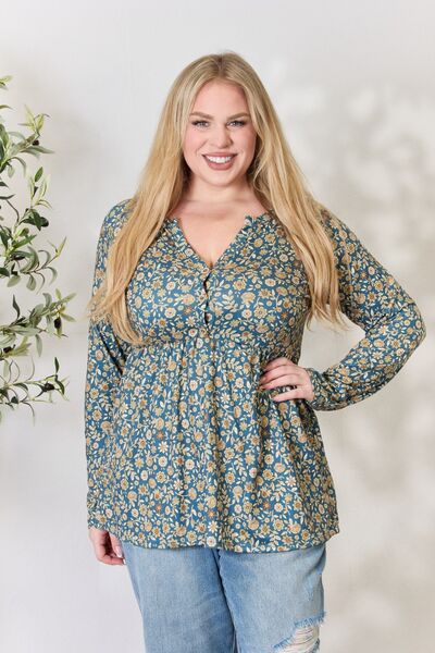 Heimish Full Size Floral Half Button Long Sleeve Blouse featuring a chic notched neckline and vibrant floral pattern.