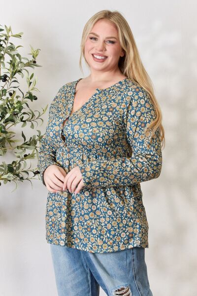 Heimish Full Size Floral Half Button Long Sleeve Blouse featuring a chic notched neckline and vibrant floral pattern.