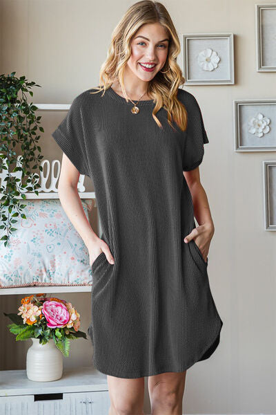 Heimish Full Size Ribbed Round Neck Short Sleeve Tee Dress in a stylish setting, showcasing its ribbed texture and classic design.
