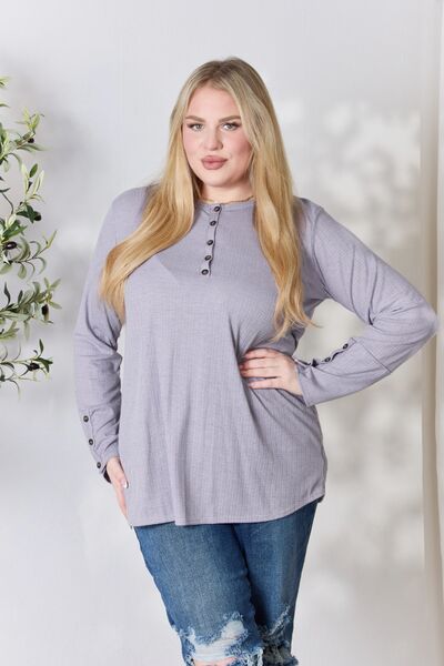 Heimish Full Size Texture Half Button Long Sleeve Top in a stylish setting, showcasing its button detailing and comfortable fit.