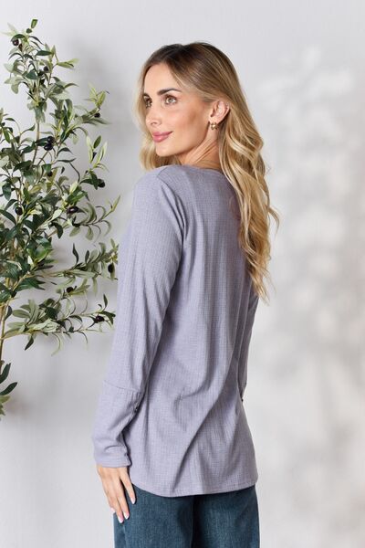 Heimish Full Size Texture Half Button Long Sleeve Top in a stylish setting, showcasing its button detailing and comfortable fit.