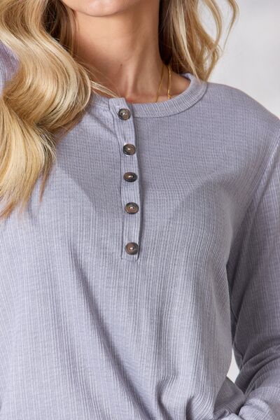 Heimish Full Size Texture Half Button Long Sleeve Top in a stylish setting, showcasing its button detailing and comfortable fit.