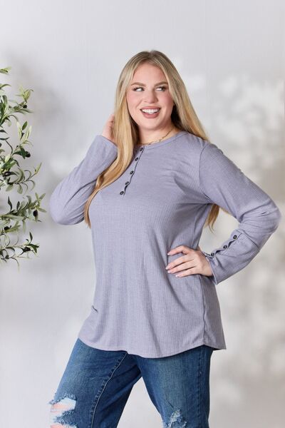 Heimish Full Size Texture Half Button Long Sleeve Top in a stylish setting, showcasing its button detailing and comfortable fit.
