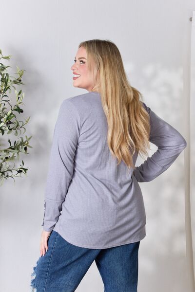 Heimish Full Size Texture Half Button Long Sleeve Top in a stylish setting, showcasing its button detailing and comfortable fit.