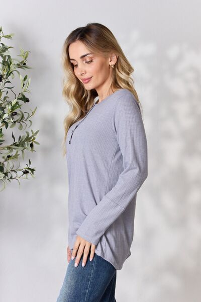 Heimish Full Size Texture Half Button Long Sleeve Top in a stylish setting, showcasing its button detailing and comfortable fit.