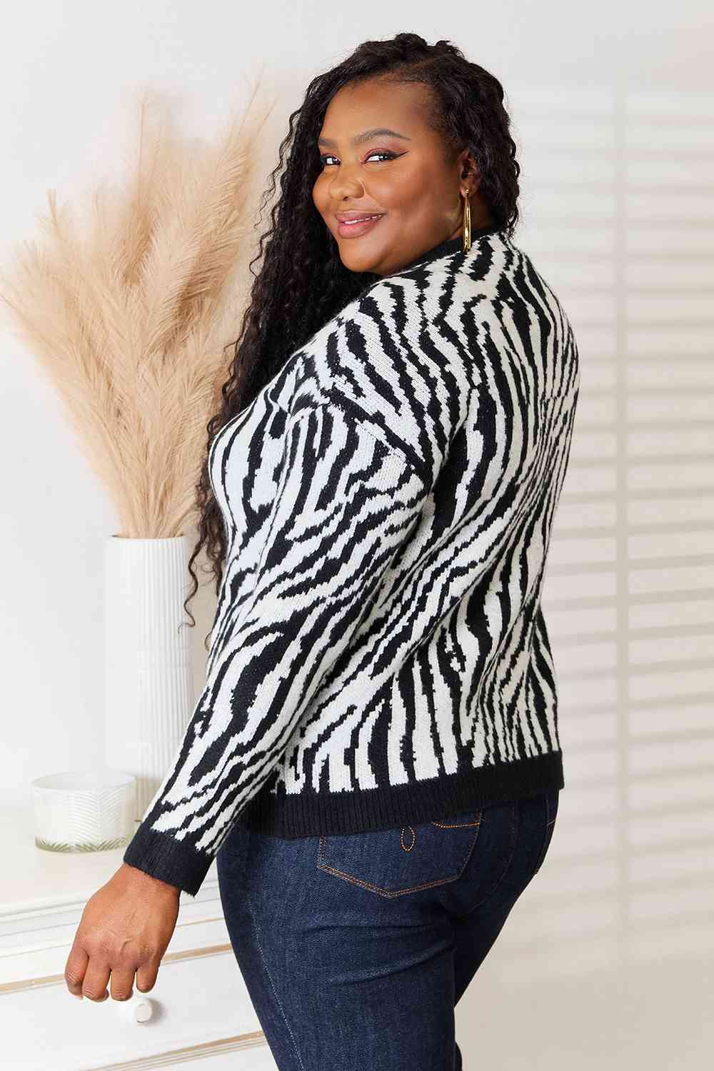 Heimsih Full Size Zebra Print Sweater featuring a classic round neck and long sleeves, showcasing a stylish zebra print design.