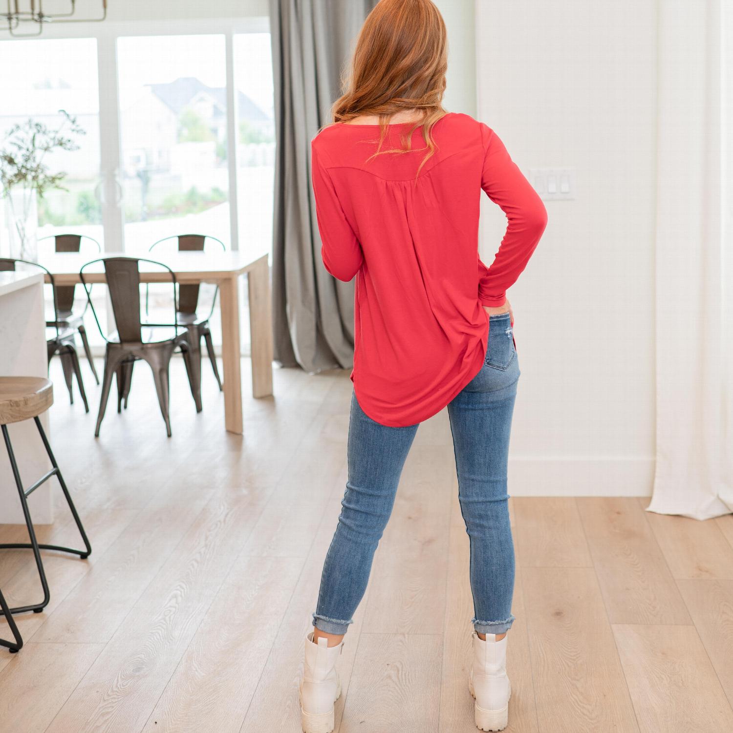 A stylish Henley Neck With Yoke Shirring Top featuring a button front, baby doll fit, and yoke shirring tunic hemline, perfect for versatile outfits.