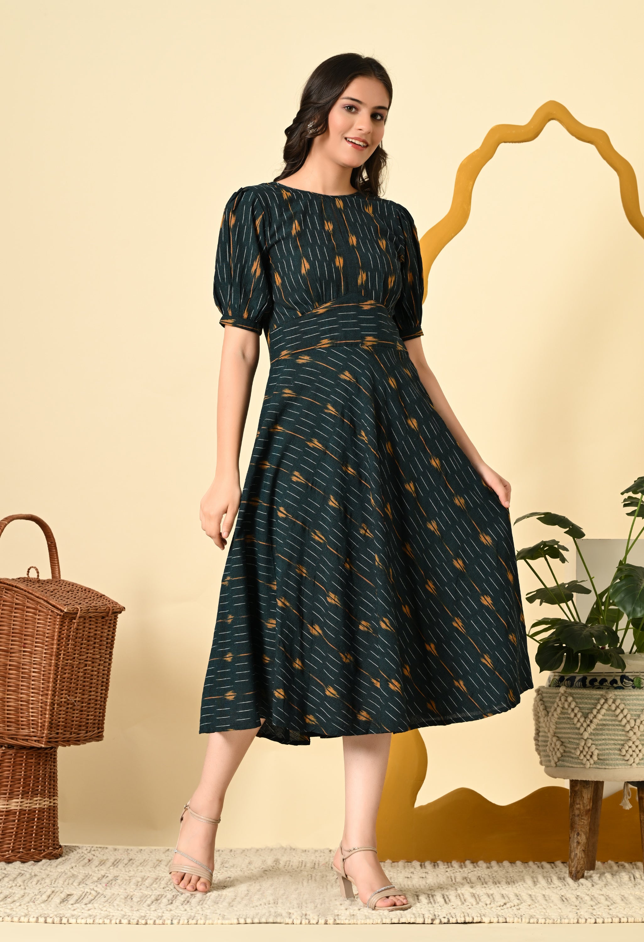 High Waist Belted Ikat Dress in green with puff sleeves and an asymmetrical hem, showcasing a stylish Ikat pattern.