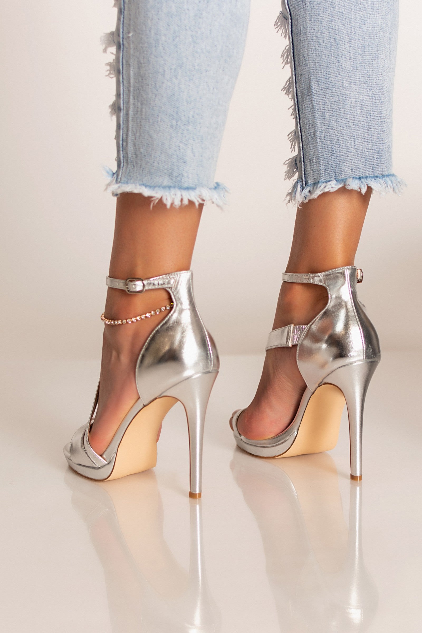 Elegant silver high-heeled sandals Madesima with ankle strap and reinforced heel.