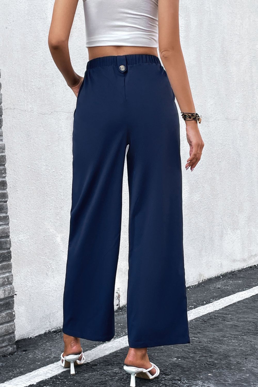 High-Rise Pleated Waist Wide Leg Pants in solid color, showcasing a stylish and minimalist design suitable for office wear.
