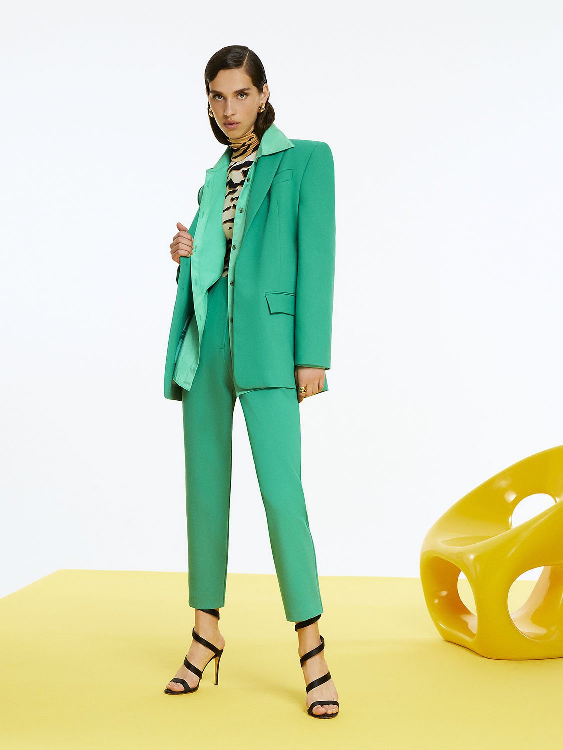 A pair of stylish high-waisted pants featuring side welt pockets and pleat details, showcasing a modern and elegant design.