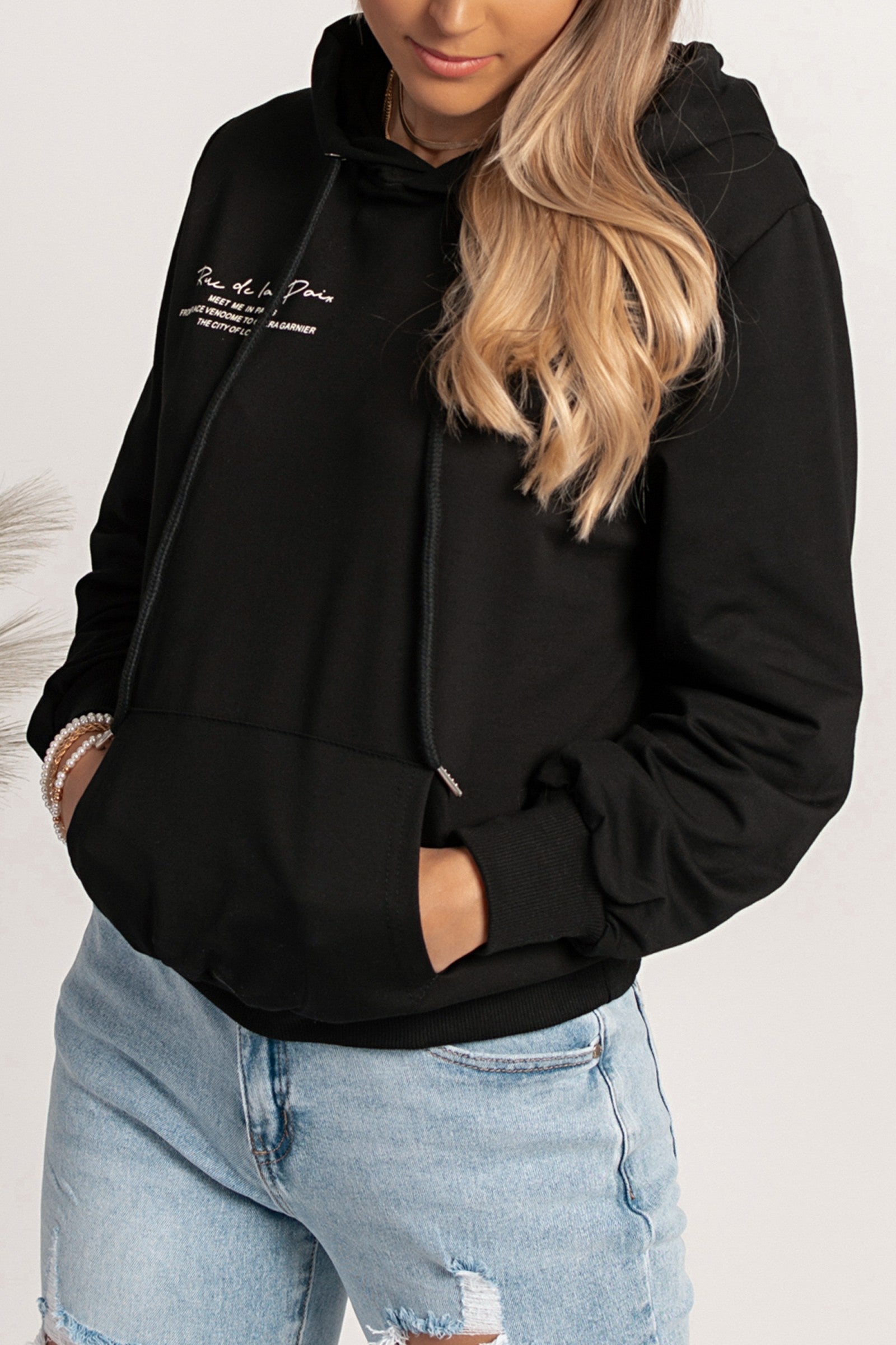 Black hoodie with Rapalla print, featuring a drawstring hood and front pocket.