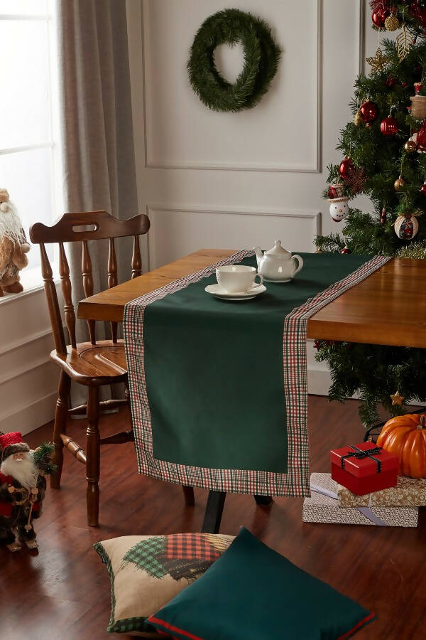 Hunter green and red plaid runner with a decorative border, perfect for holiday decor on tables or mantles.