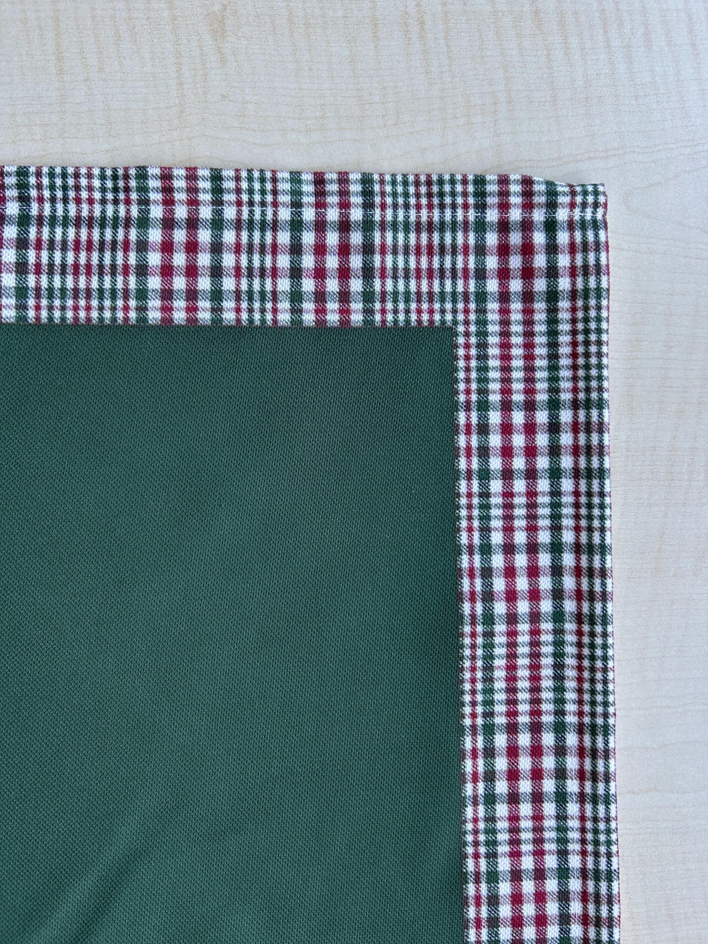 Hunter green and red plaid runner with a decorative border, perfect for holiday decor on tables or mantles.