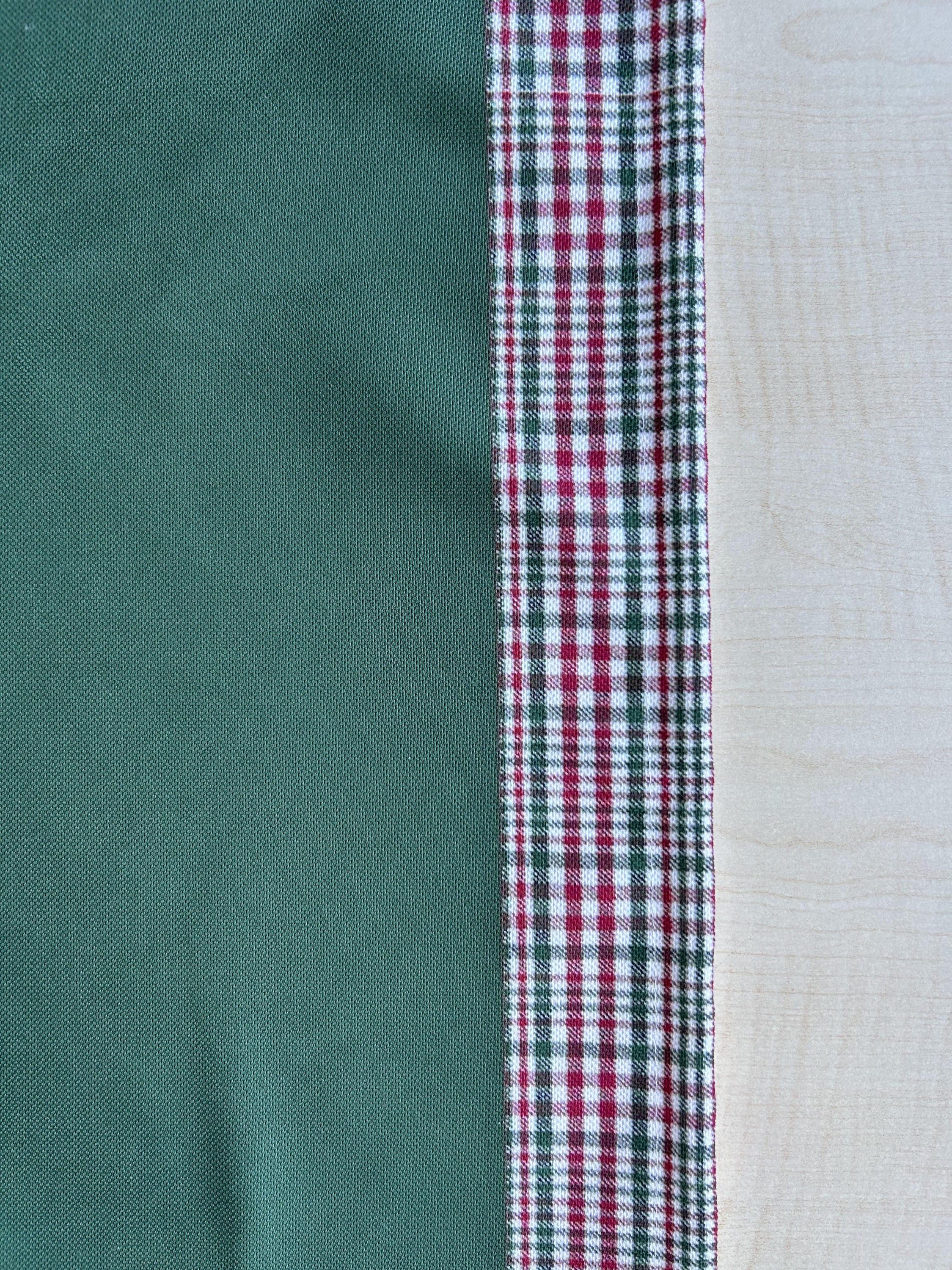 Hunter green and red plaid runner with a decorative border, perfect for holiday decor on tables or mantles.