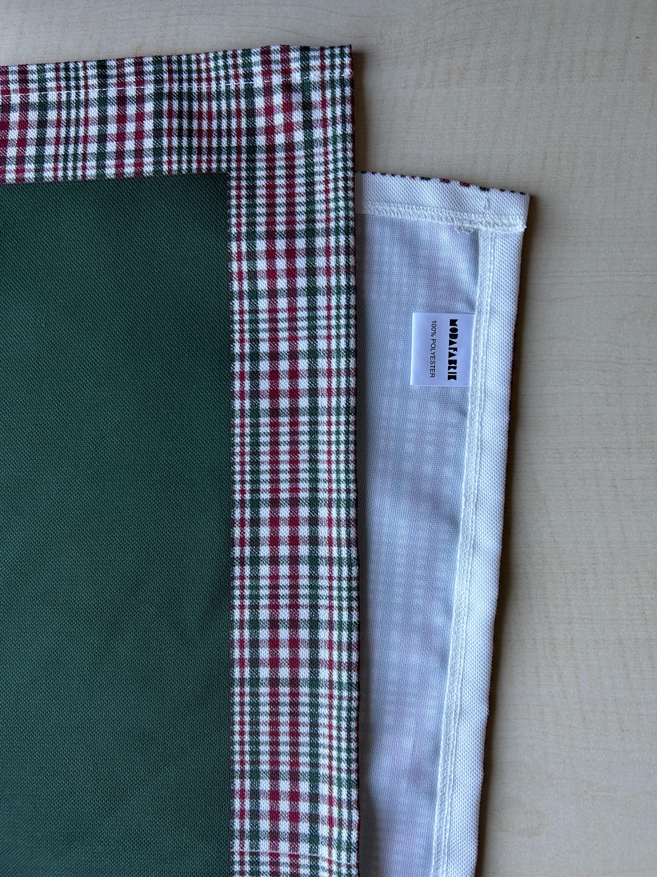 Hunter green and red plaid runner with a decorative border, perfect for holiday decor on tables or mantles.