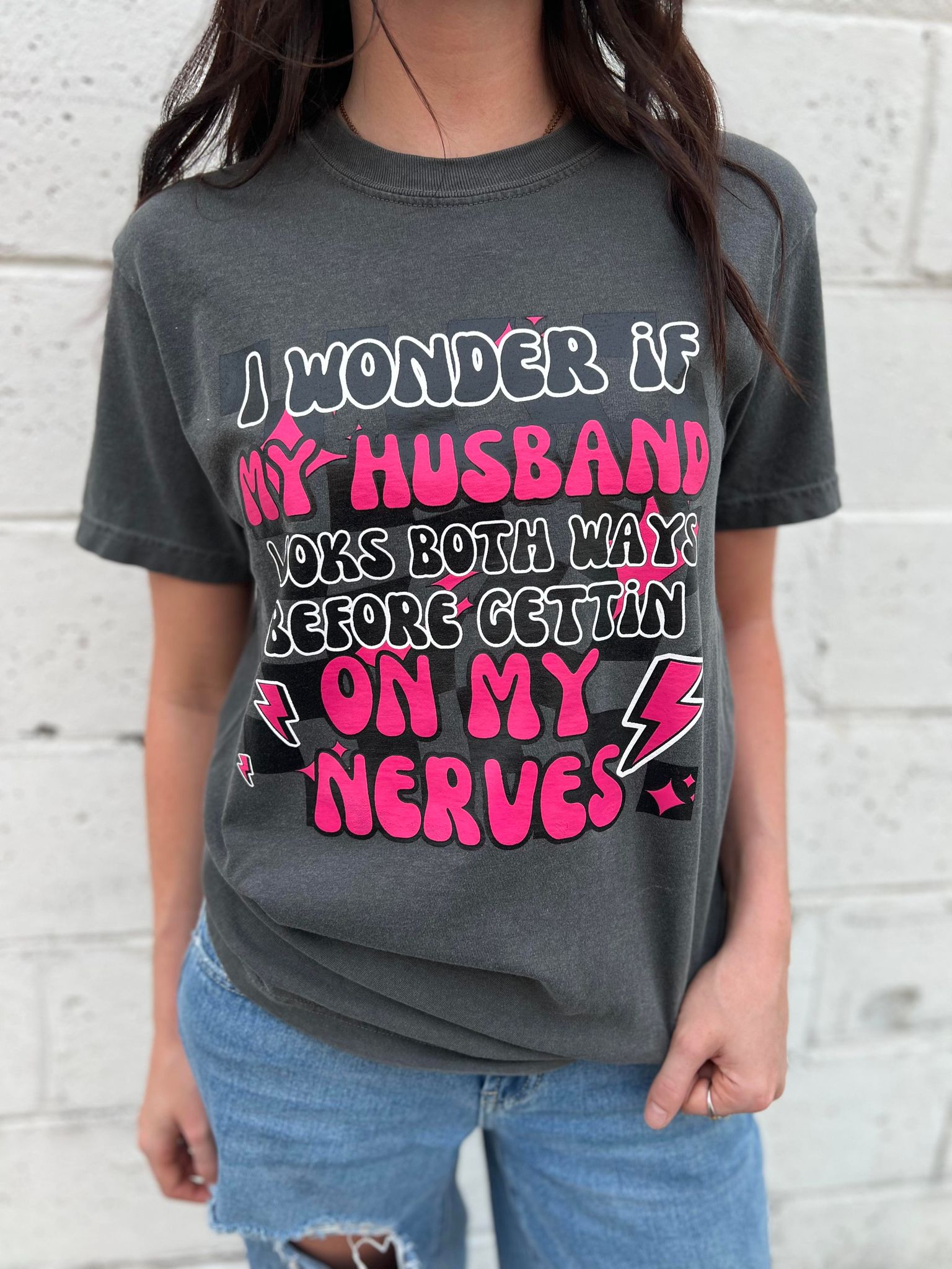 A fun and cute 'I Wonder if My Husband' tee in Pepper color, made from 100% cotton, showcasing its comfortable fit.