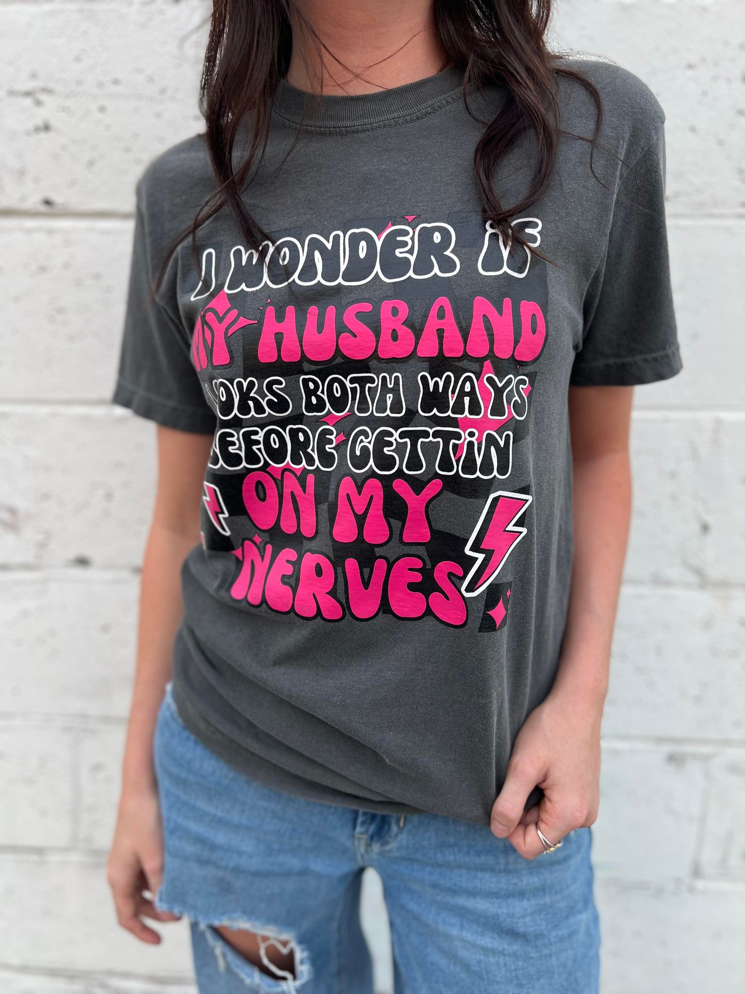 A fun and cute 'I Wonder if My Husband' tee in Pepper color, made from 100% cotton, showcasing its comfortable fit.