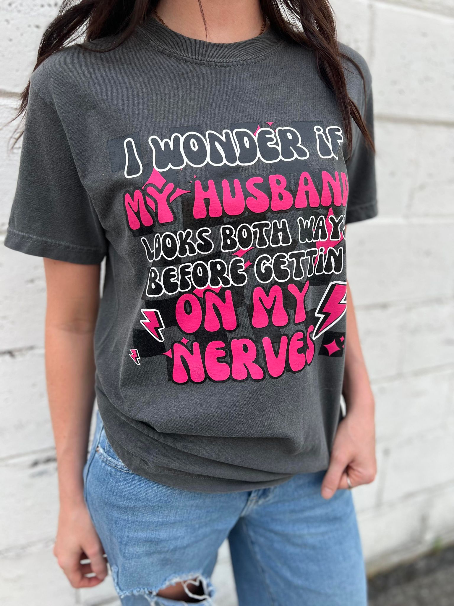 A fun and cute 'I Wonder if My Husband' tee in Pepper color, made from 100% cotton, showcasing its comfortable fit.