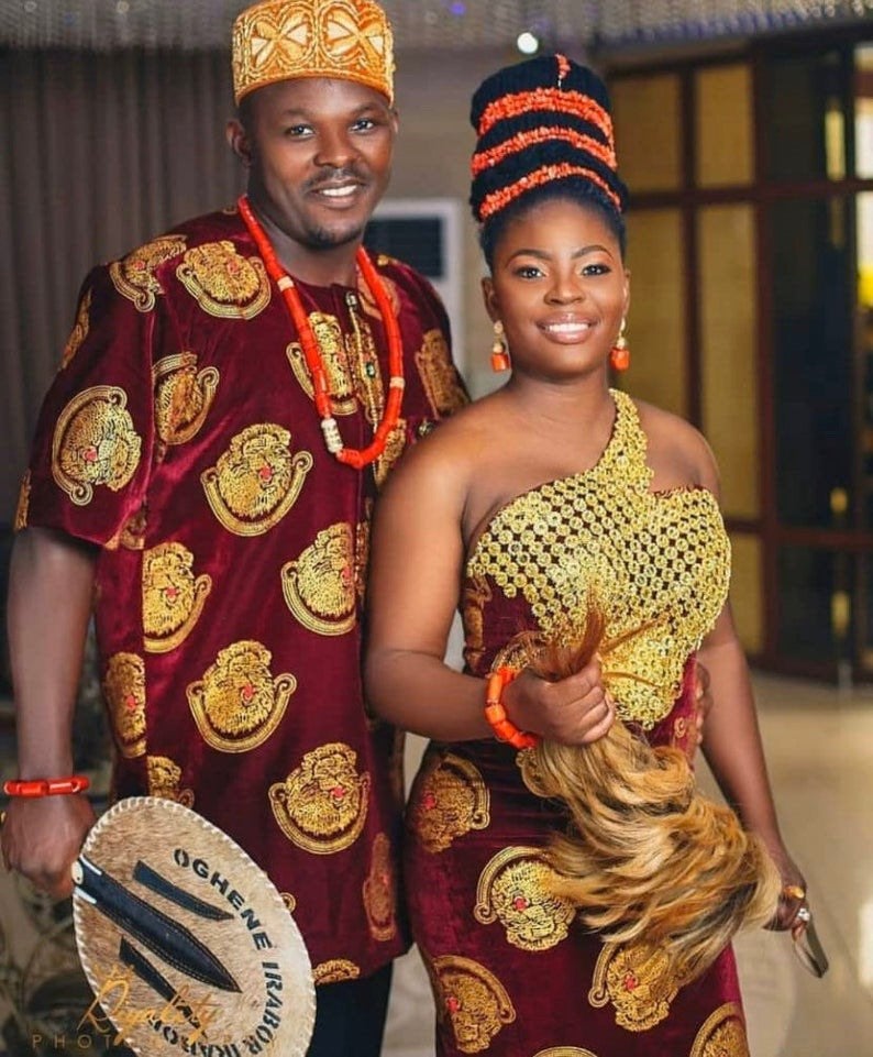 Traditional Igbo couple attire featuring vibrant colors, intricate designs, and cultural accessories for a wedding.