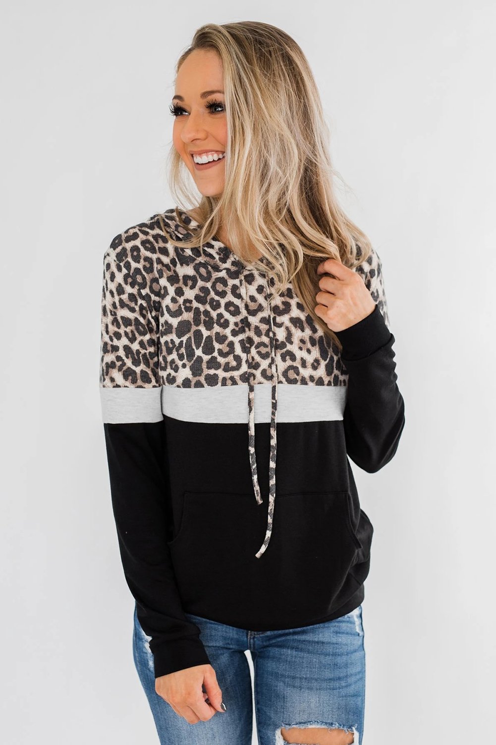 Into the Jungle Color Block Hoodie featuring a leopard design, lightweight fabric, and drawstring hood.