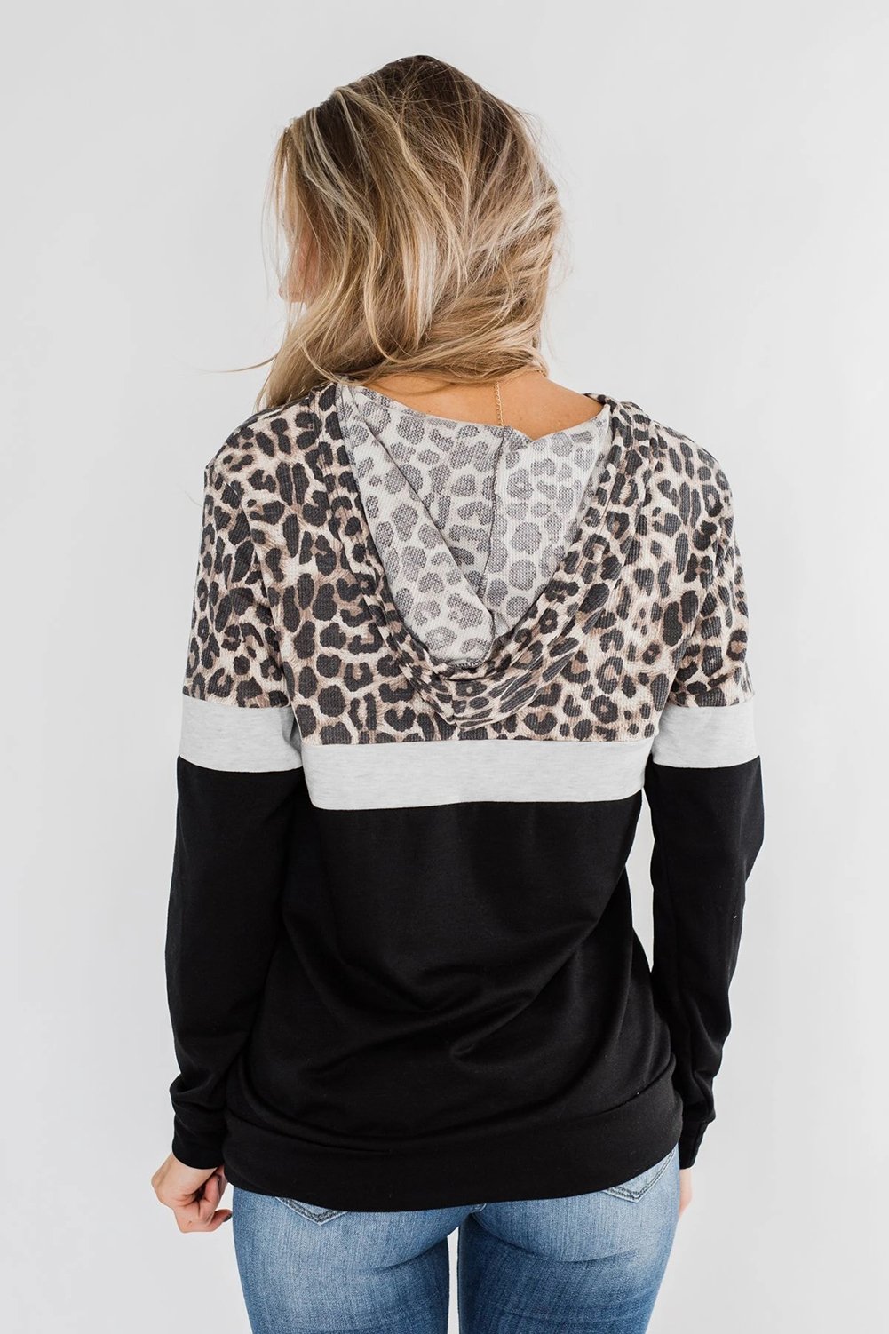 Into the Jungle Color Block Hoodie featuring a leopard design, lightweight fabric, and drawstring hood.