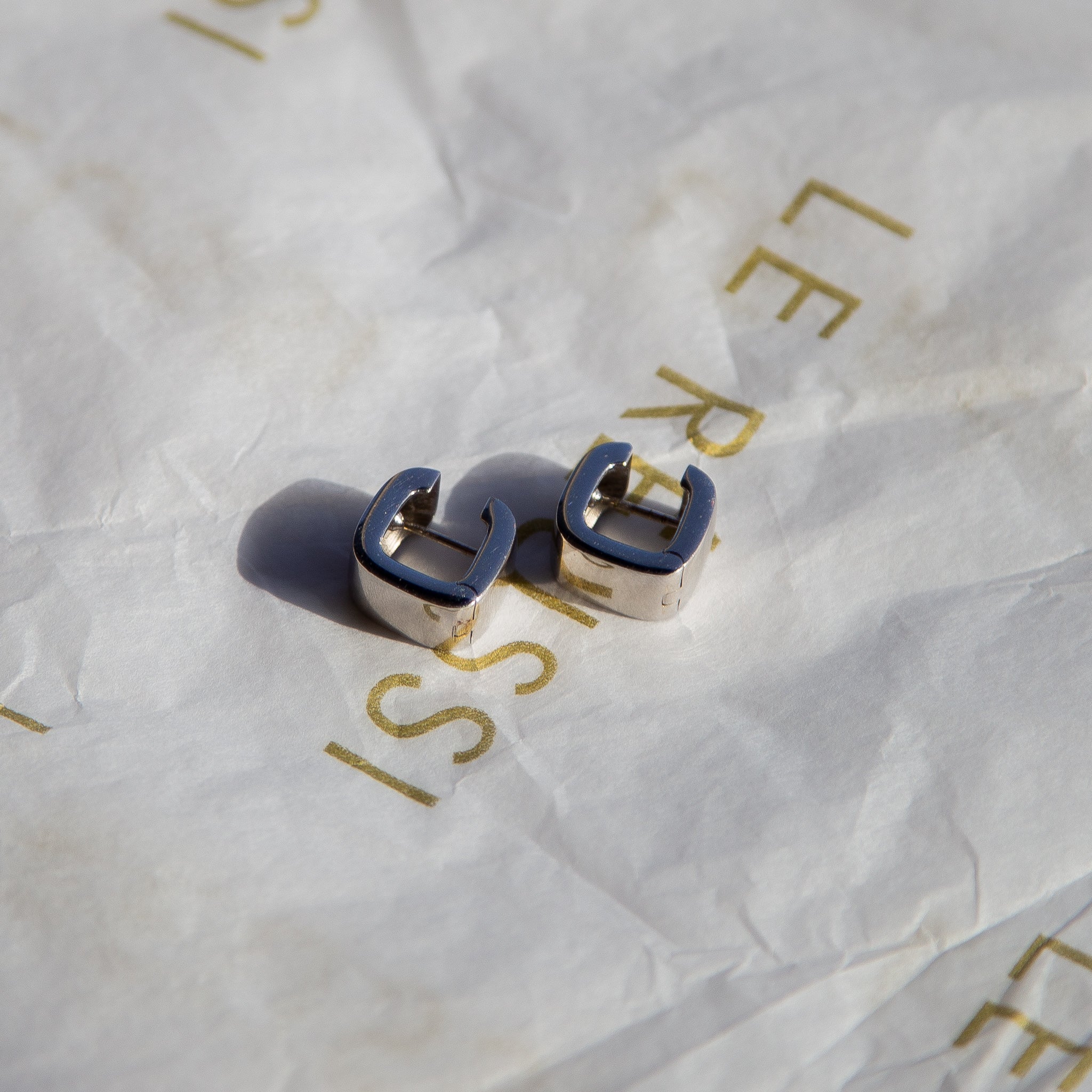 Elegant Italian Sterling Silver Square Hoop Earrings showcasing a modern design with a polished finish.