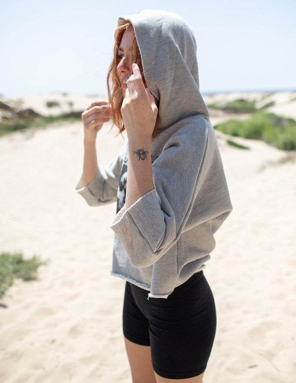 Cropped Janis Joplin hoodie in heathered gray with graphic print, featuring raw baseball hem and 3/4 sleeves.