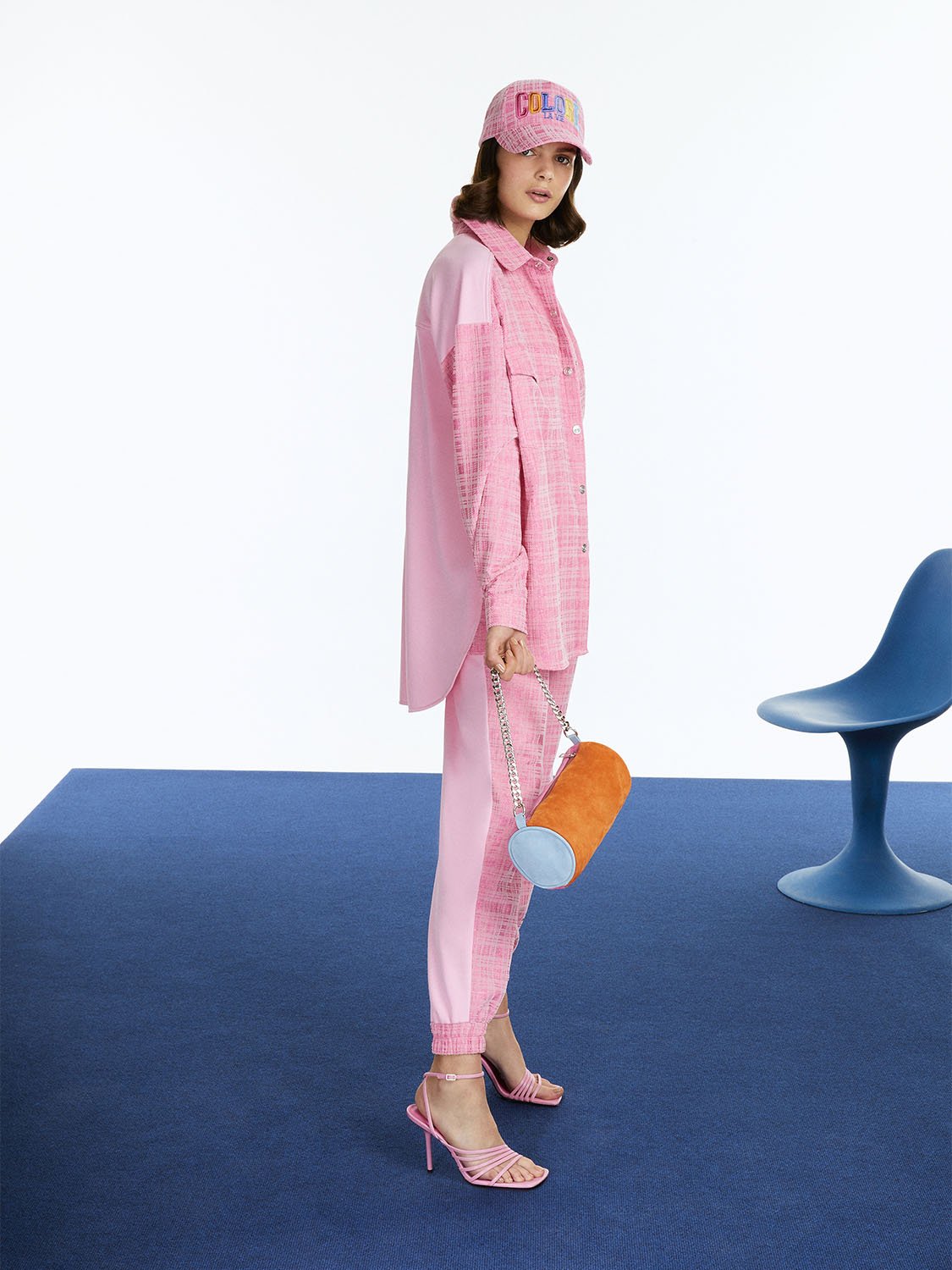 High-waisted jogging pants in vibrant orange, pink, and blue colors with elastic waistband and side pockets.