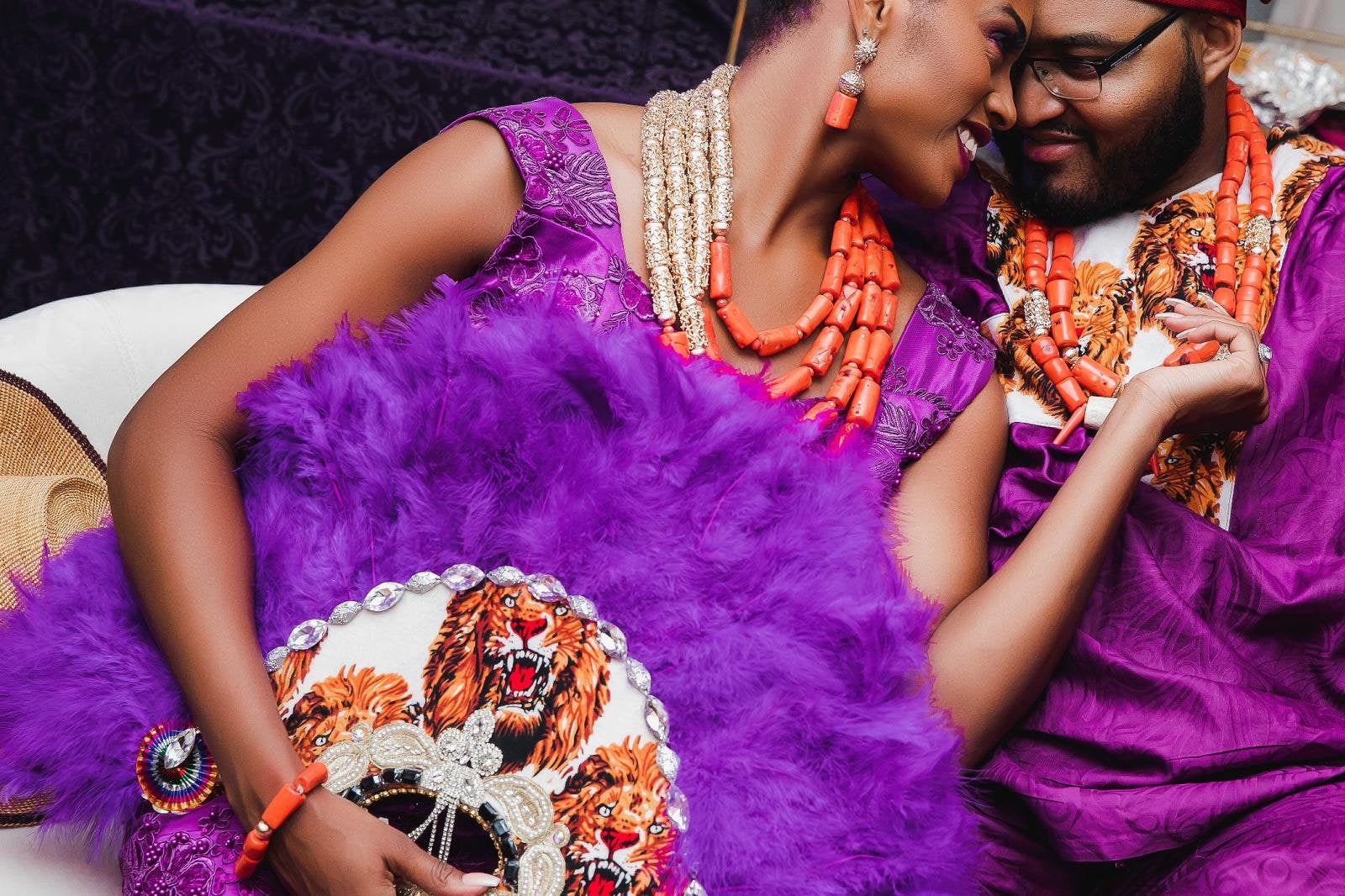 A vibrant Jumbo feather fan featuring intricate isiagu lion head fabric design, showcasing colorful feathers and a unique handcrafted style.