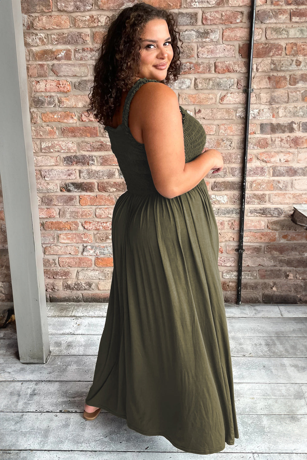 Jungle Green Shirred Bust Sleeveless Plus Size Maxi Dress displayed on a mannequin, showcasing its flattering silhouette and vibrant color.