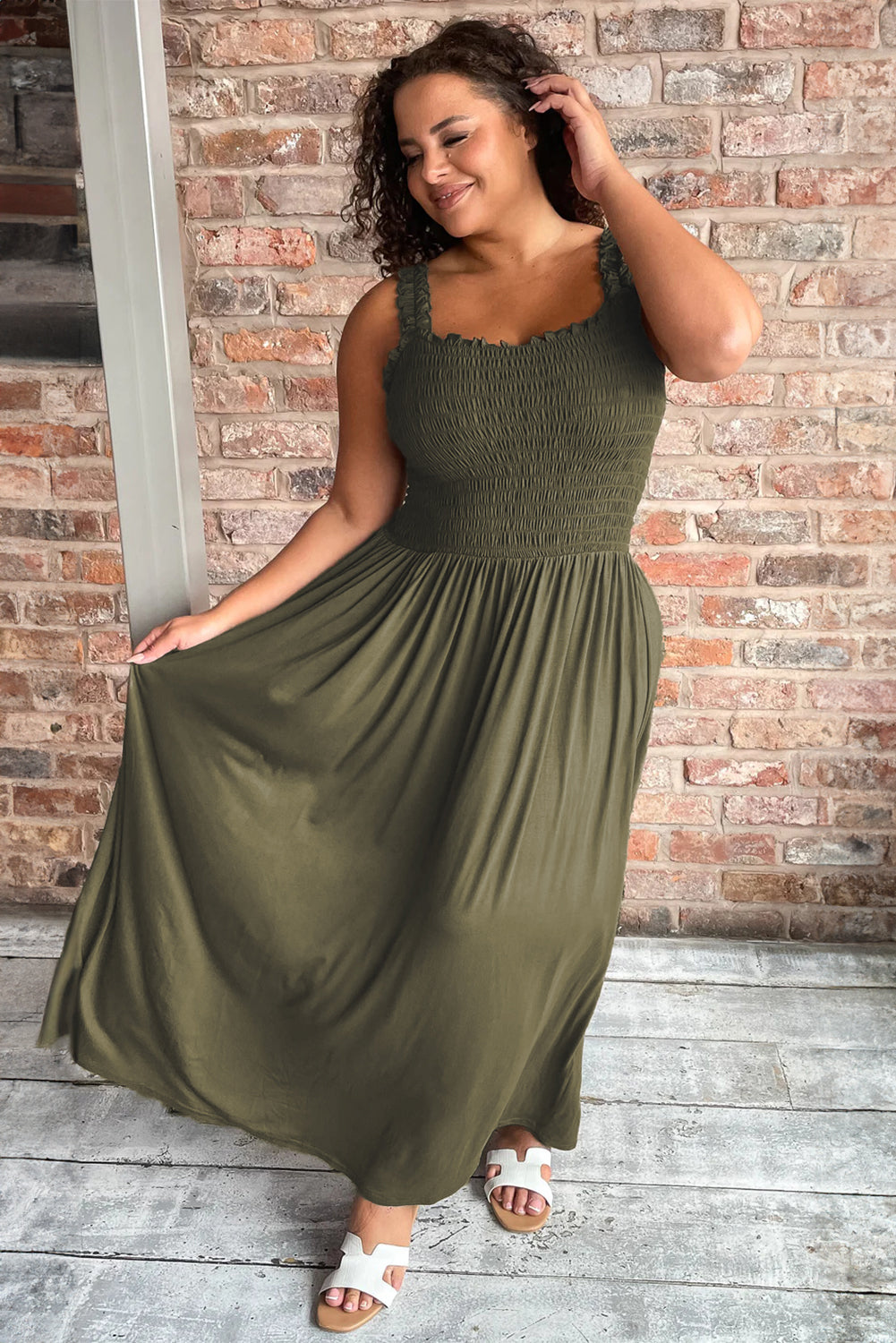 Jungle Green Shirred Bust Sleeveless Plus Size Maxi Dress displayed on a mannequin, showcasing its flattering silhouette and vibrant color.