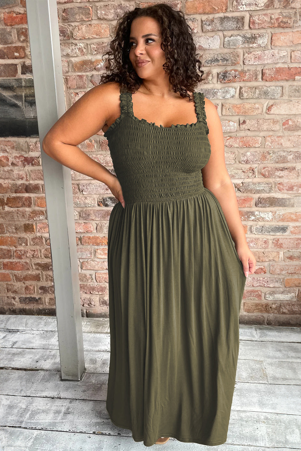 Jungle Green Shirred Bust Sleeveless Plus Size Maxi Dress displayed on a mannequin, showcasing its flattering silhouette and vibrant color.