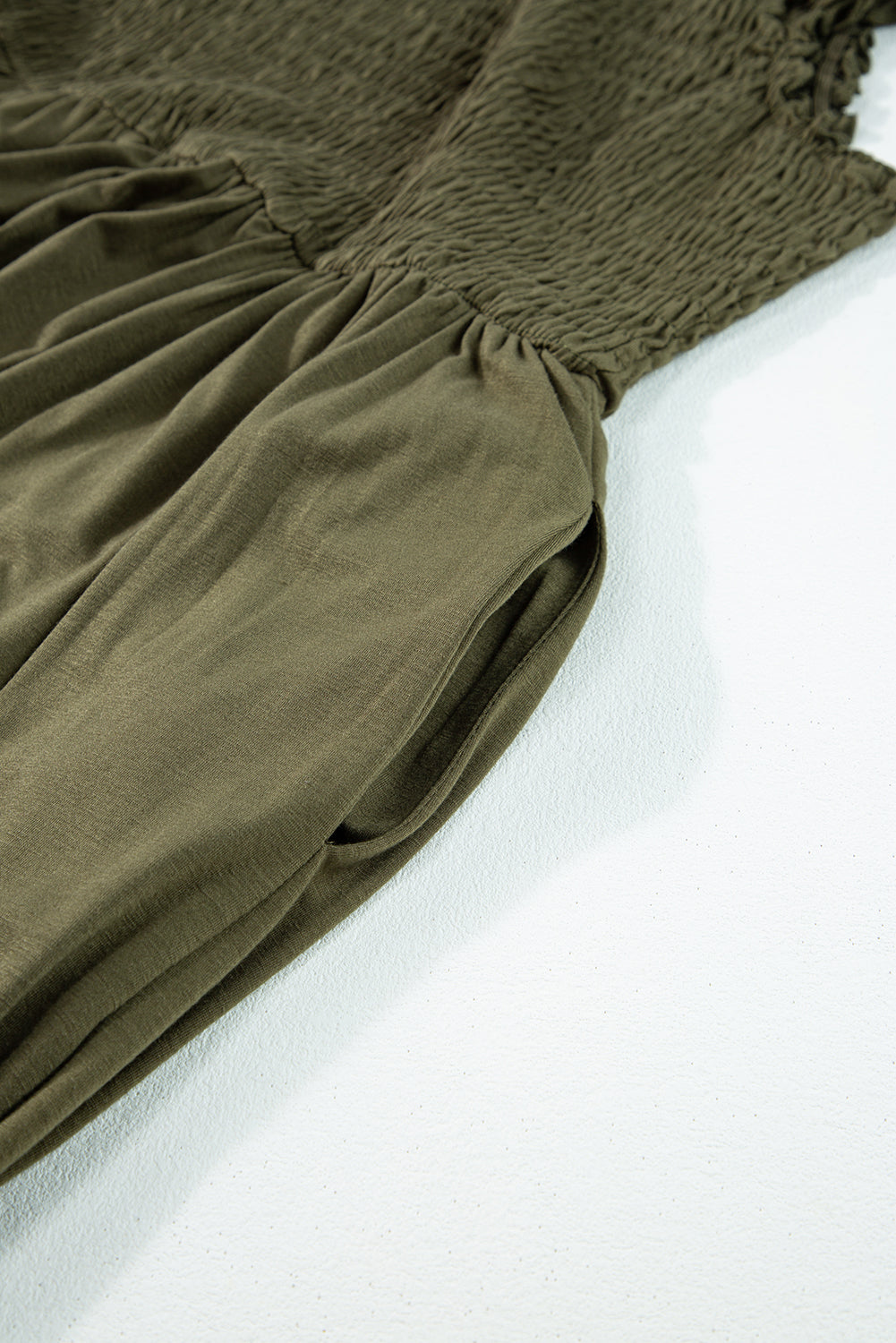 Jungle Green Shirred Bust Sleeveless Plus Size Maxi Dress displayed on a mannequin, showcasing its flattering silhouette and vibrant color.