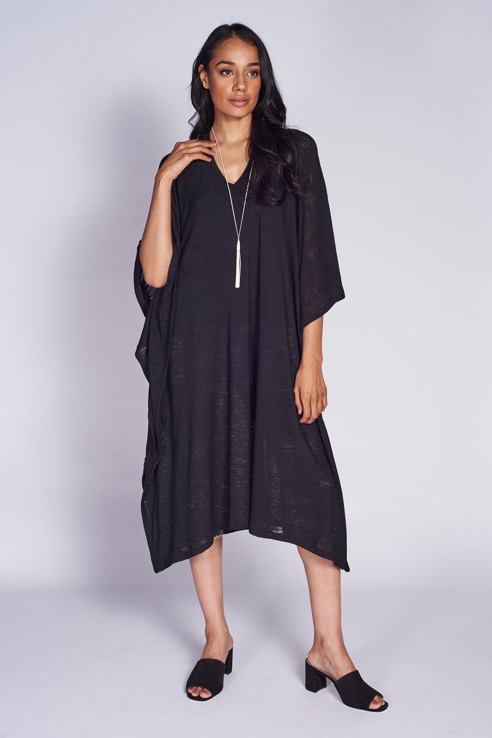 A stylish midi kaftan dress made from textured mesh knit, featuring a V-neck design, perfect for resort wear.