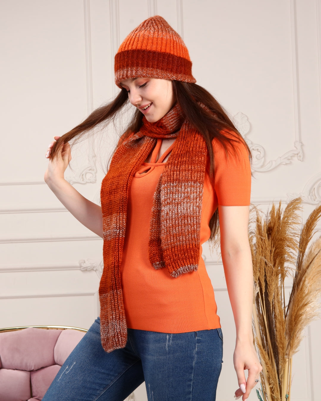 A stylish women's knitted beanie and scarf set in vibrant colors, made from soft acrylic wool, perfect for cold weather.