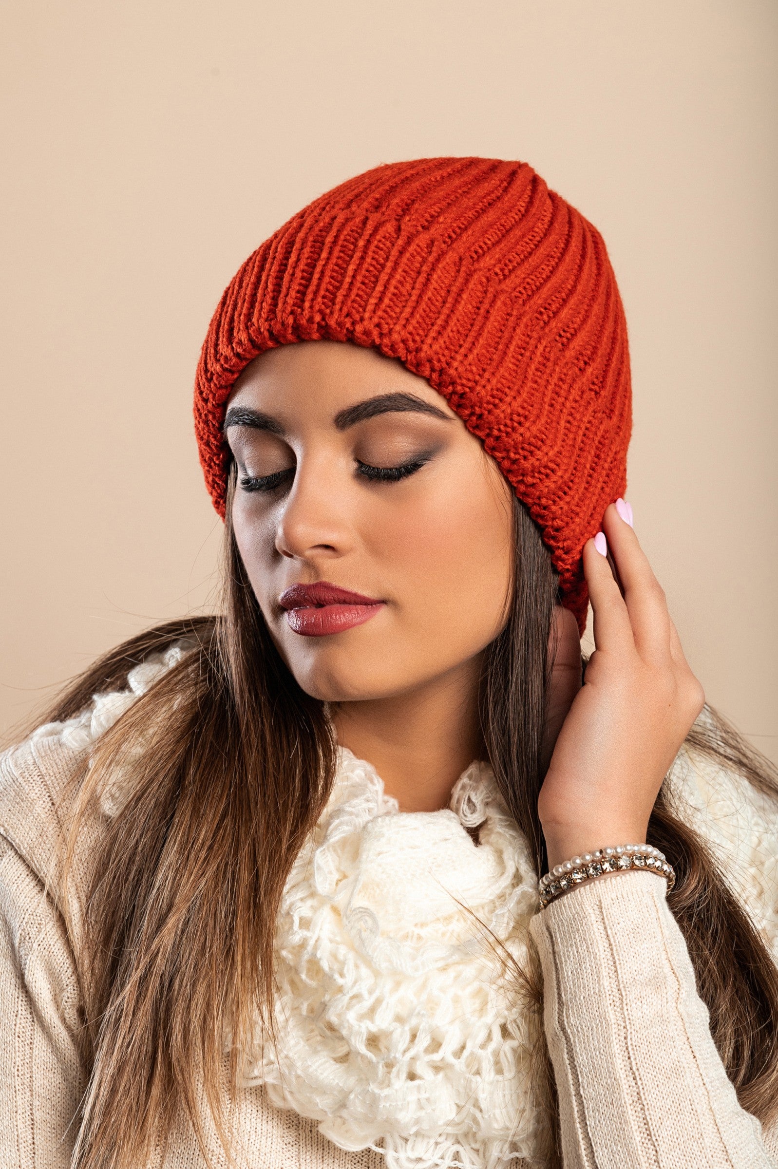 A stylish brick knitted hat featuring a ribbed knit design and rolled hem, made from soft and warm fabric.