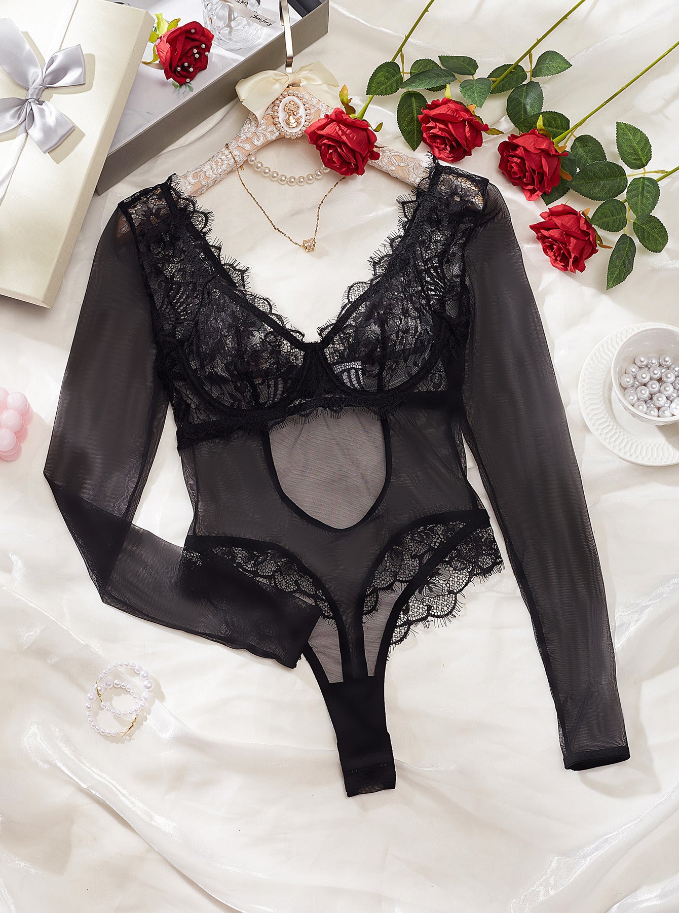 A sexy backless jumpsuit featuring intricate lace stitching and a see-through mesh design, perfect for stylish occasions.