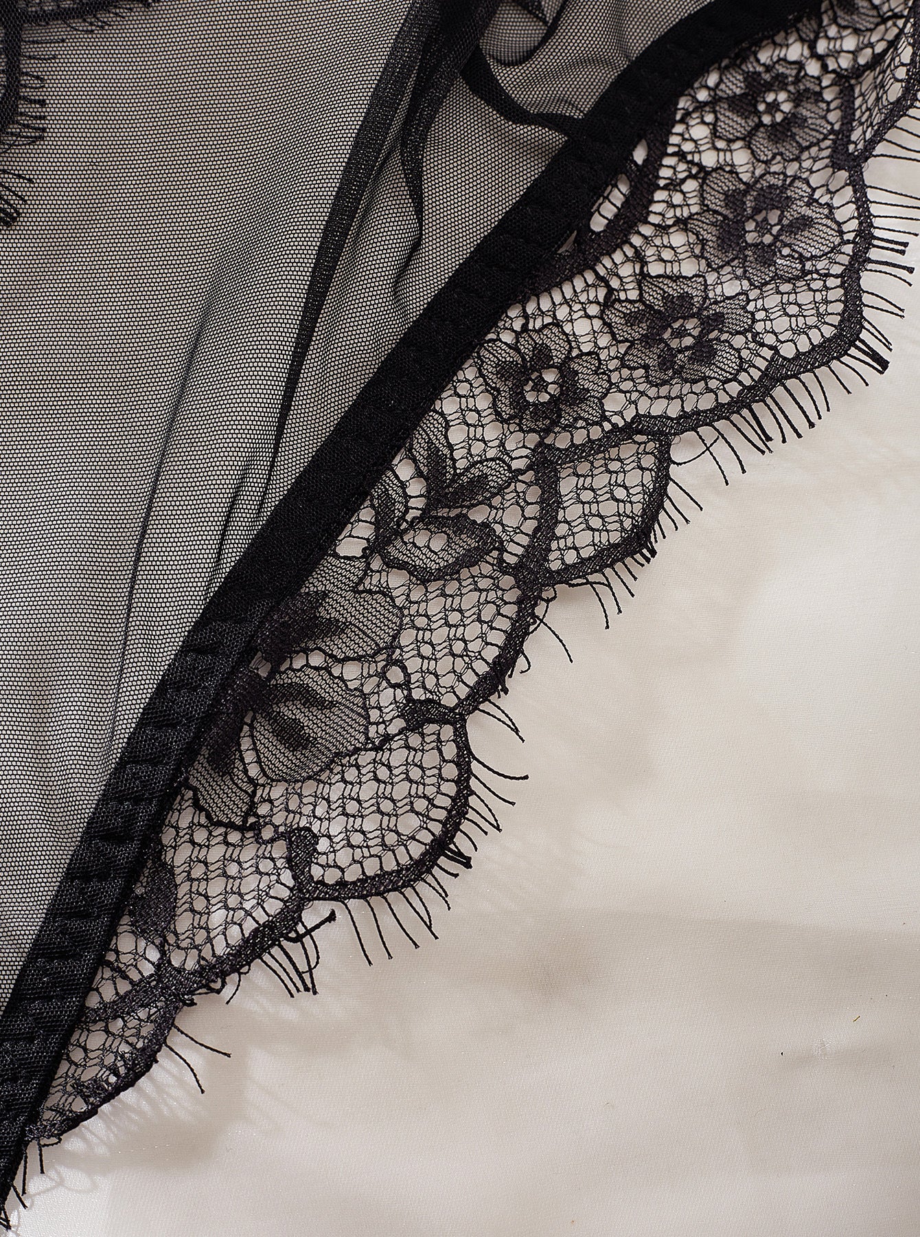 A sexy backless jumpsuit featuring intricate lace stitching and a see-through mesh design, perfect for stylish occasions.