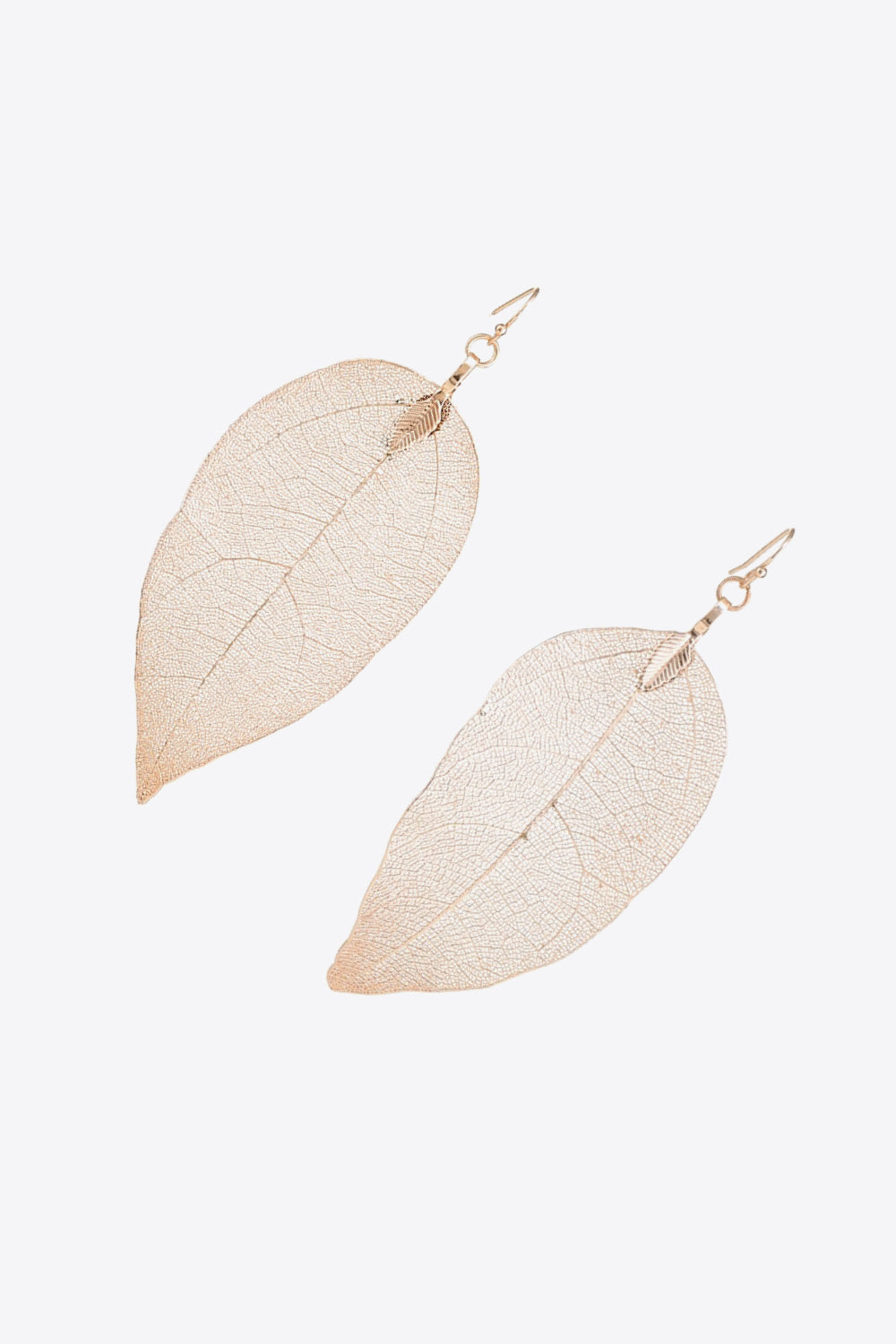 Elegant leaf-shaped dangle earrings made of polished copper, showcasing a modern design.